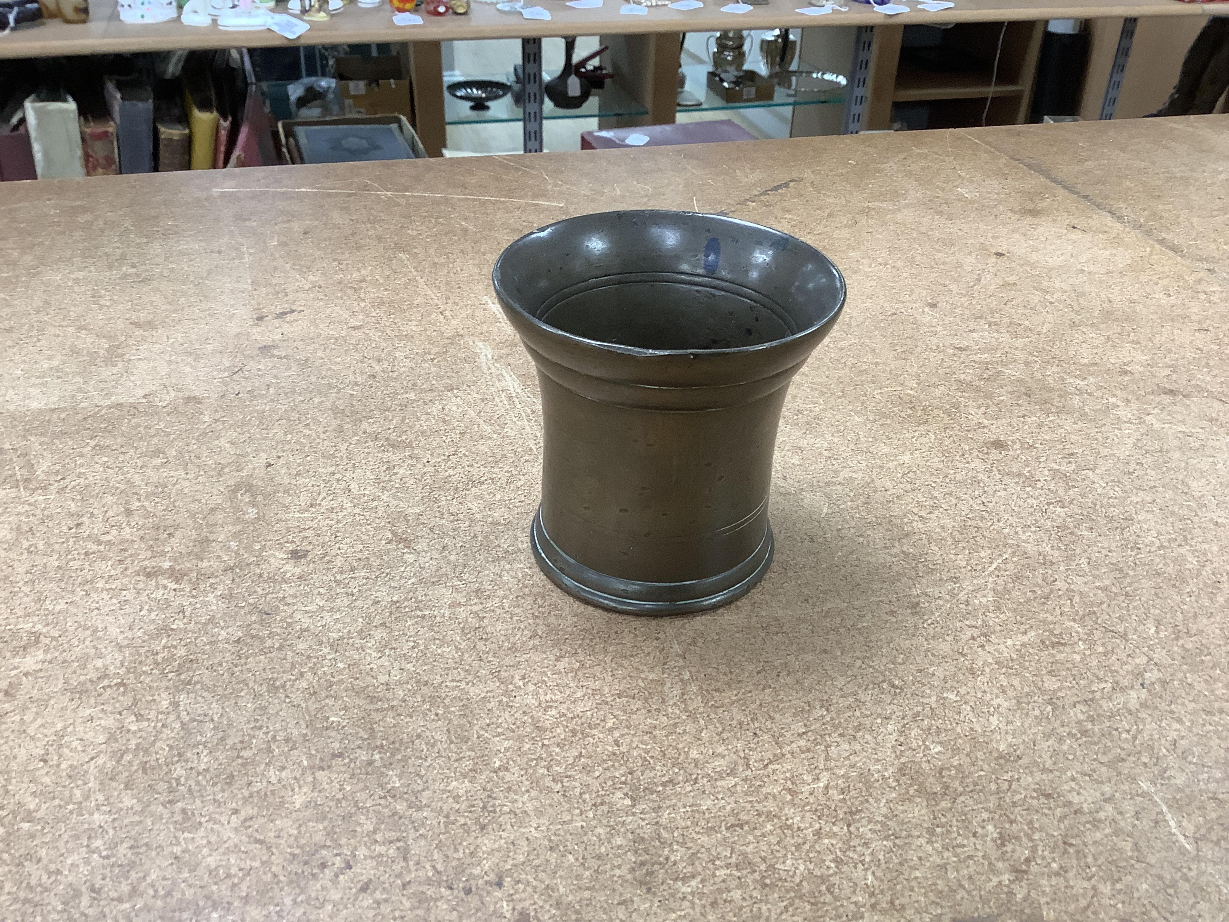 Sundry items to include a large pestle, spice grinder, flat iron on stand, bronze mortar and three other items, largest 42cm in length